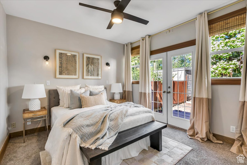 Carpeted bedroom featuring french doors, access to exterior, baseboards, and a ceiling fan