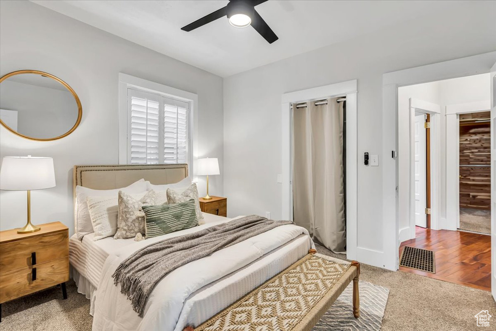 Carpeted bedroom with ceiling fan