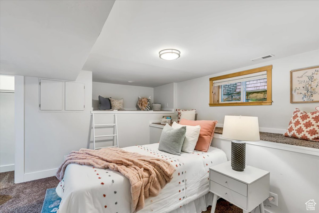 Bedroom featuring carpet floors and baseboards