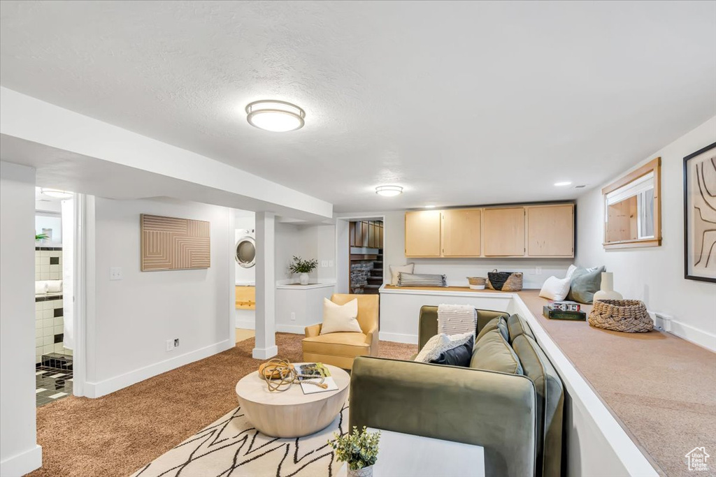 Living area with light colored carpet and baseboards