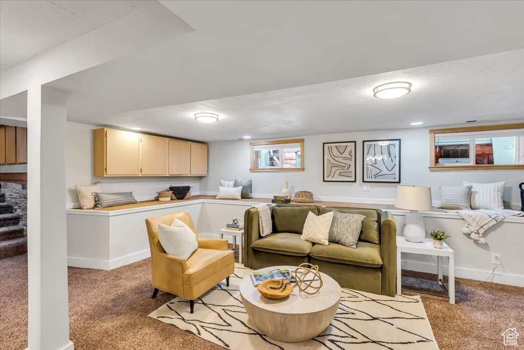 Living room with light colored carpet and baseboards
