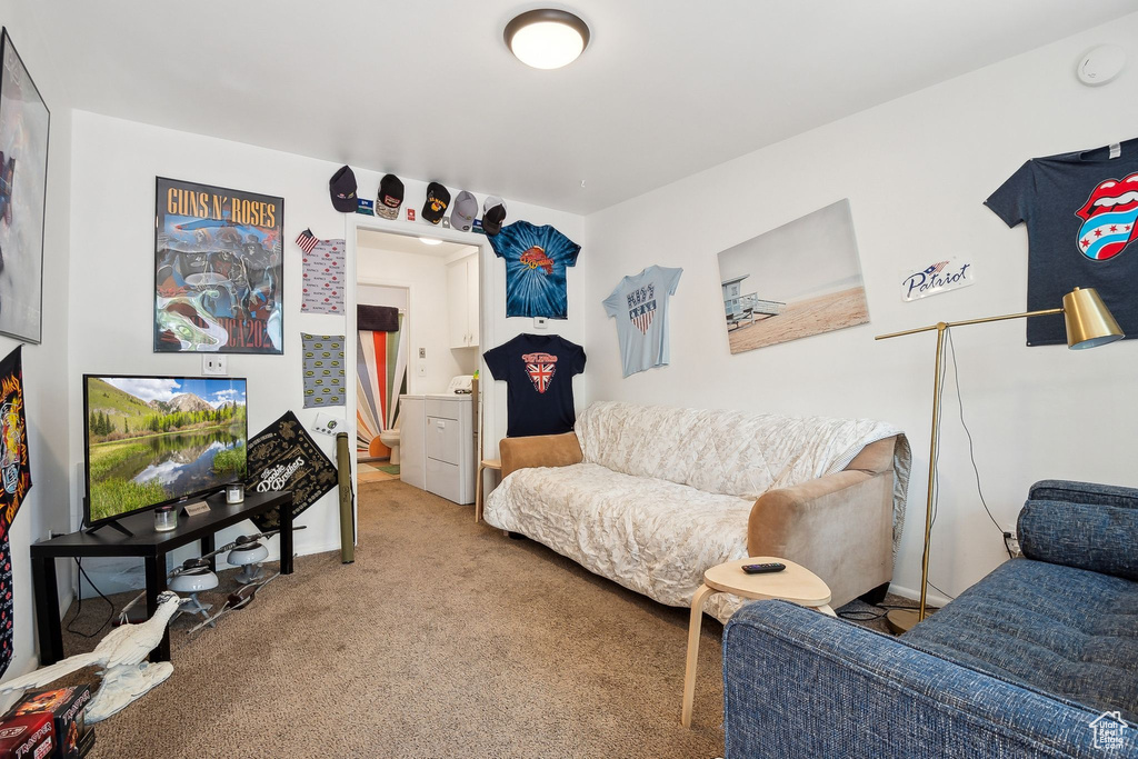 Living area featuring washer / clothes dryer and carpet