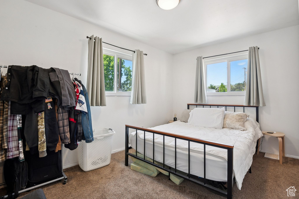 Bedroom featuring carpet flooring and baseboards