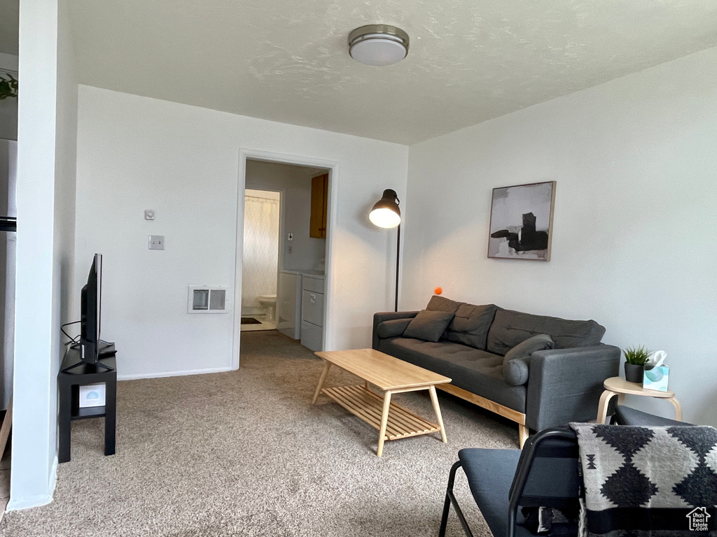 Living room with carpet floors and baseboards