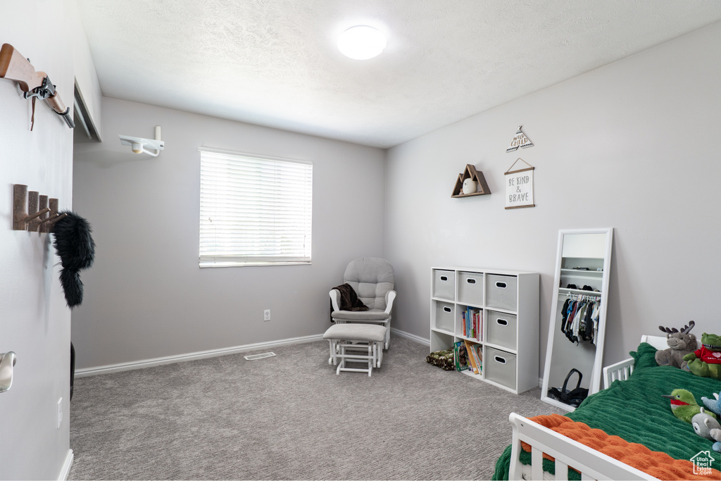 Carpeted bedroom featuring baseboards