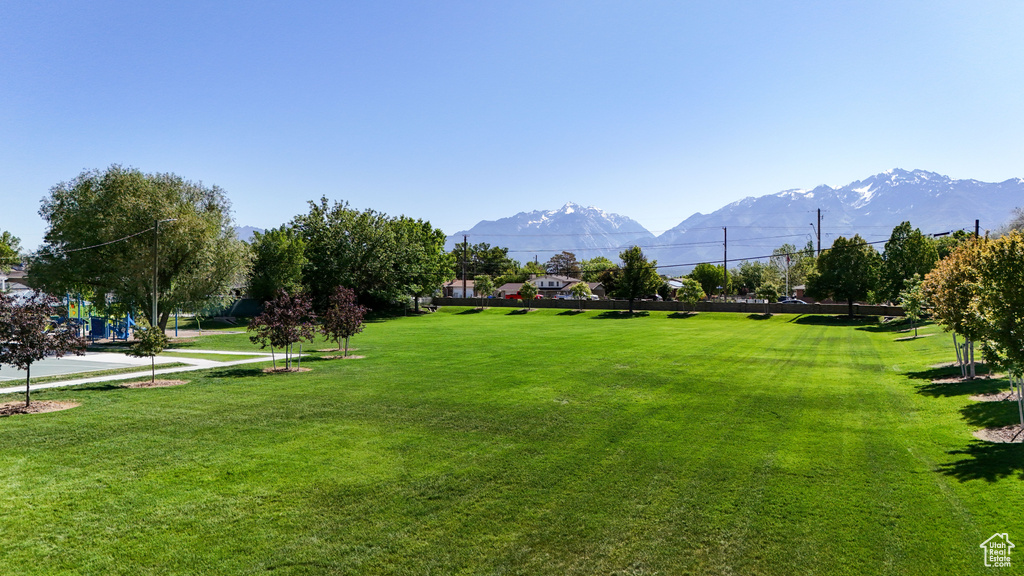 View of property\\\'s community with a mountain view and a lawn