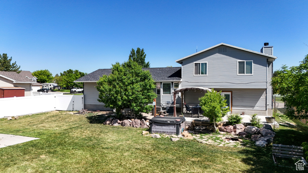 Back of property with a patio, a gate, and a chimney