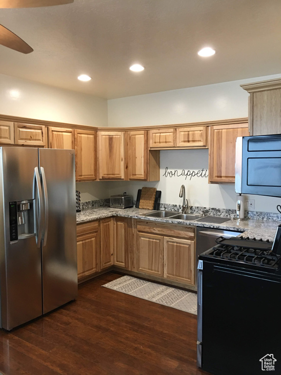 Kitchen featuring stainless steel appliances, a sink, dark wood-type flooring, a ceiling fan, and recessed lighting
