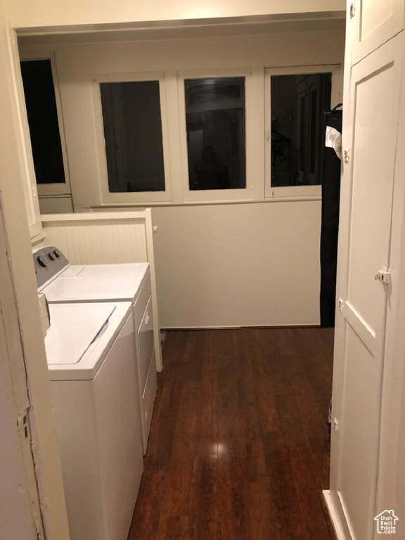 Laundry area with washer and dryer and dark wood finished floors