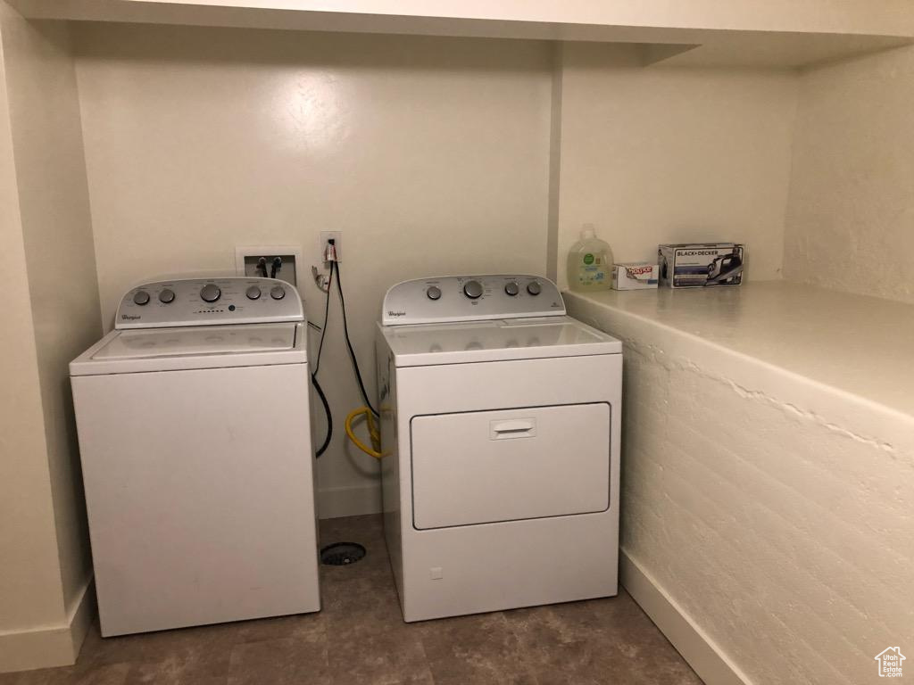 Laundry room with washer and dryer and baseboards