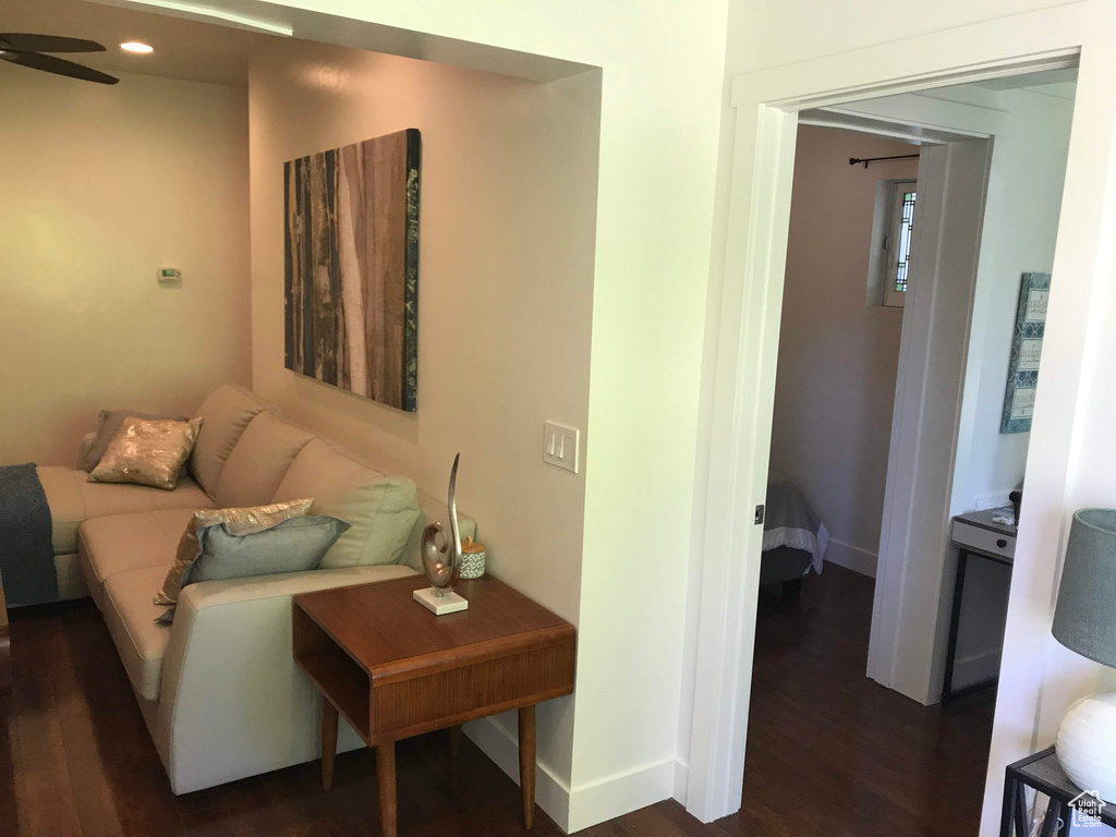 Living room with dark wood-type flooring, baseboards, ceiling fan, and recessed lighting