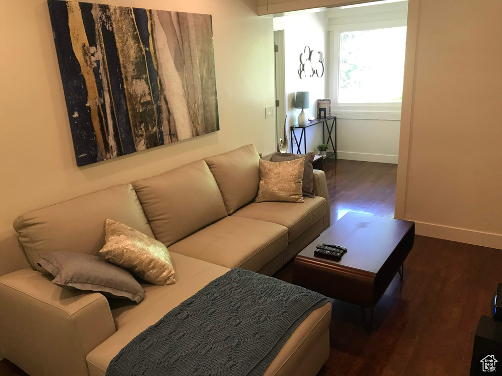 Living area with wood finished floors and baseboards
