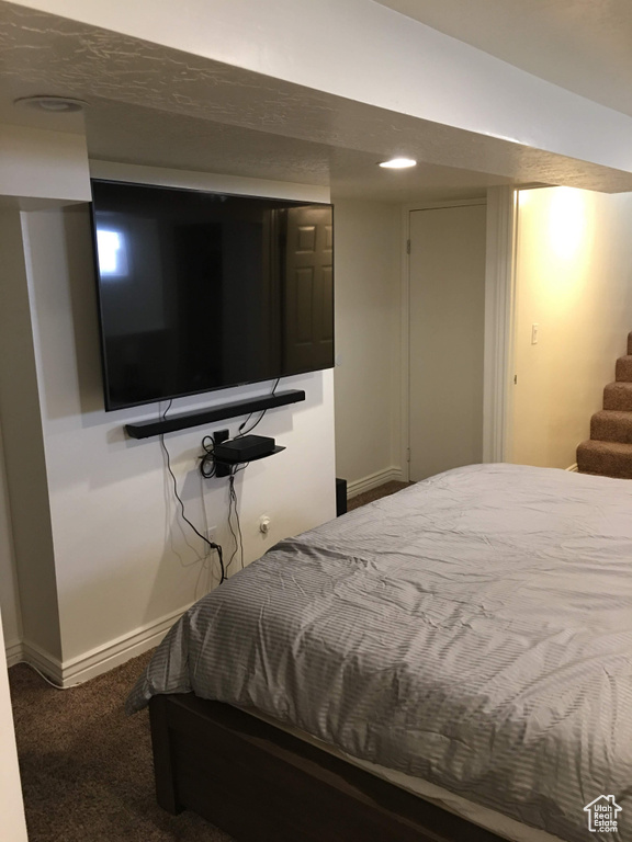 Bedroom with carpet flooring and baseboards