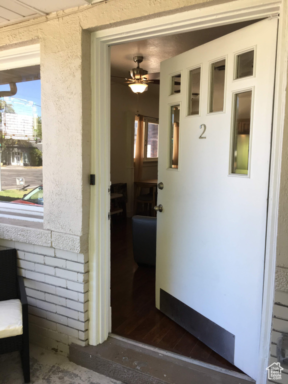 Doorway to property featuring stucco siding