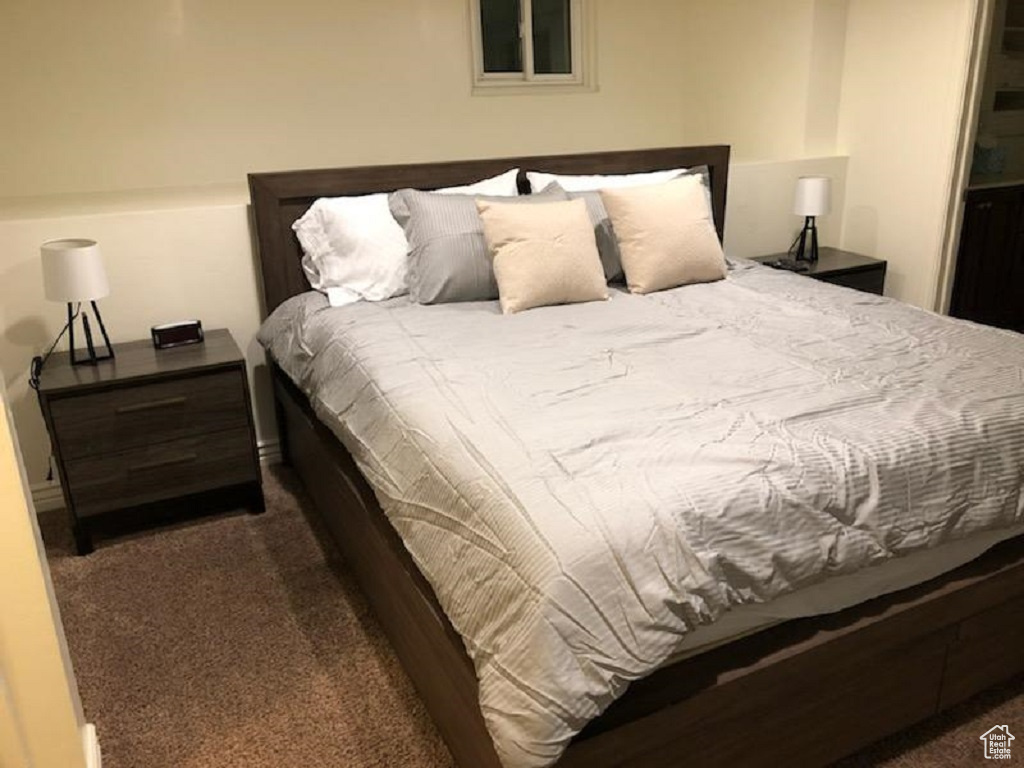 Bedroom featuring dark carpet