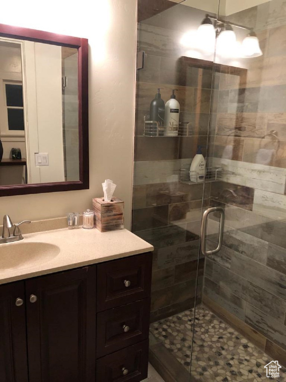 Full bathroom featuring vanity and a shower stall