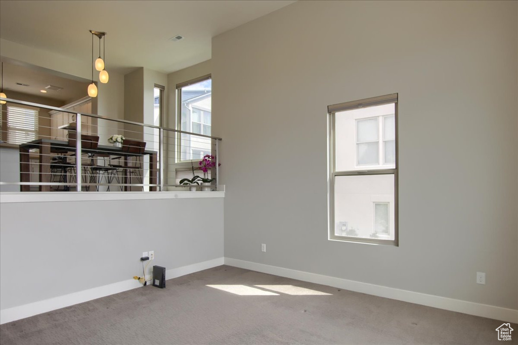 Carpeted empty room featuring baseboards
