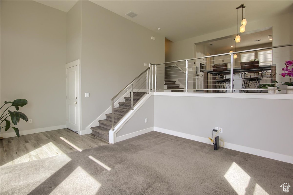 Stairs featuring carpet, baseboards, and wood finished floors