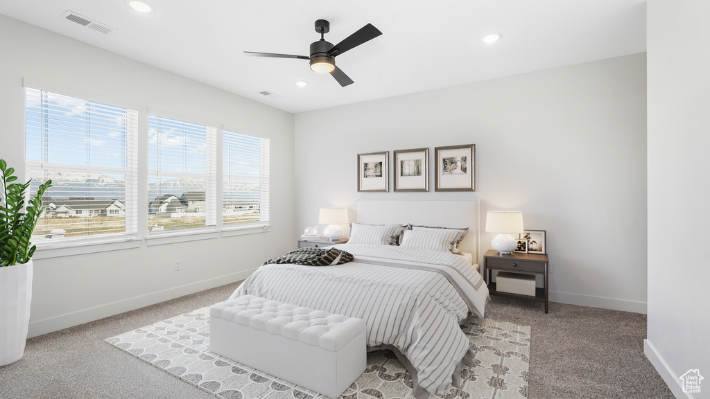 Carpeted bedroom featuring baseboards, recessed lighting, and ceiling fan