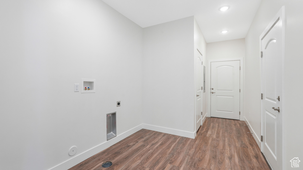 Laundry room featuring hookup for an electric dryer, hookup for a washing machine, wood finished floors, baseboards, and recessed lighting
