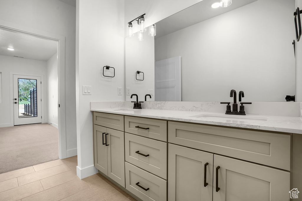 Bathroom featuring double vanity and baseboards