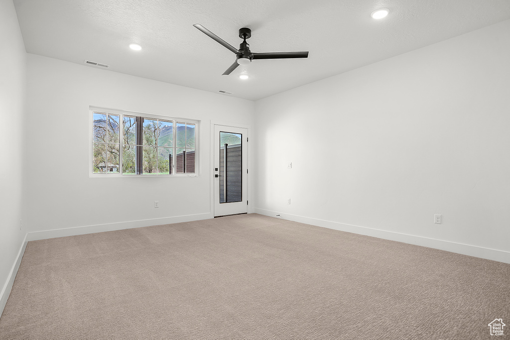 Unfurnished room featuring a ceiling fan, recessed lighting, baseboards, and light carpet
