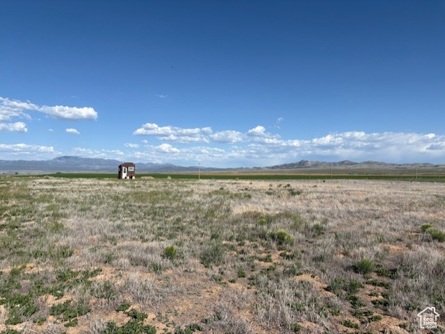 View of undeveloped land with rural landscape and mountains