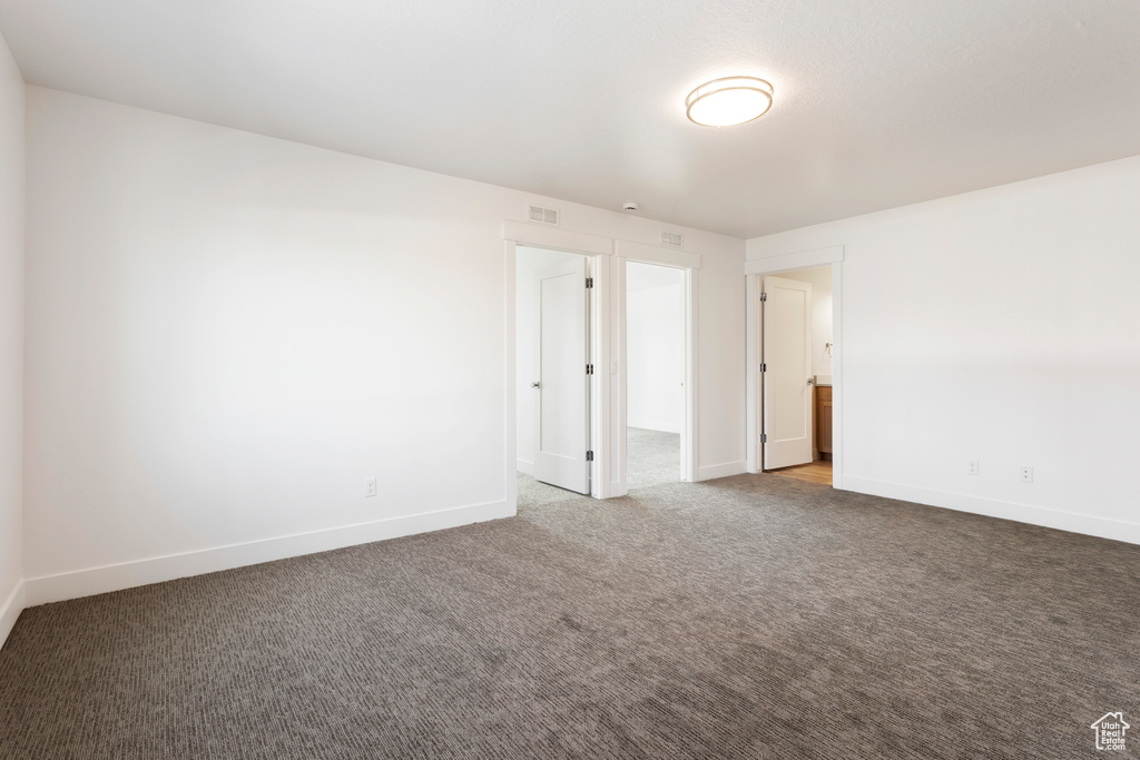 Carpeted empty room with baseboards