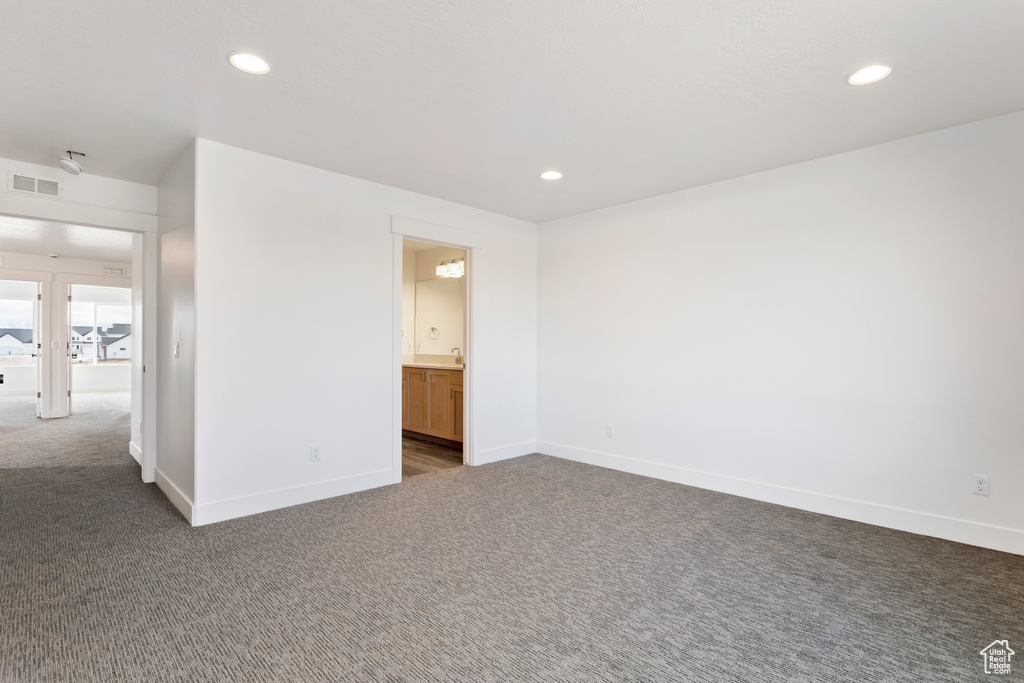 Carpeted empty room featuring recessed lighting and baseboards
