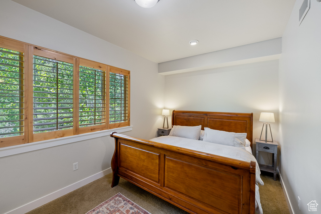 Bedroom featuring carpet floors and baseboards
