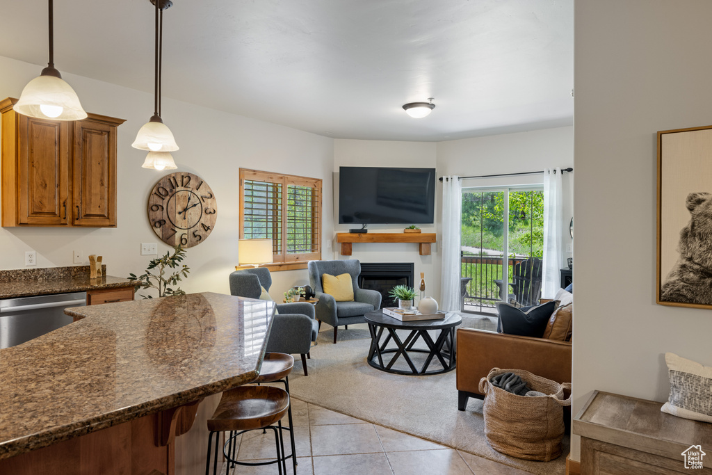Living area featuring light tile patterned floors and a fireplace