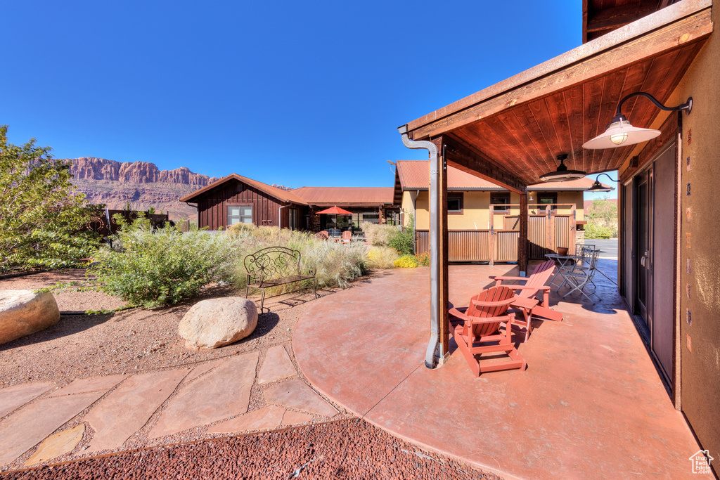 View of patio / terrace featuring ceiling fan and a mountain view