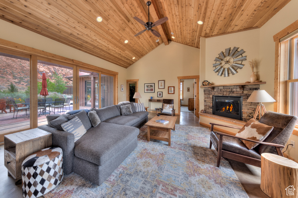 Living area with wood ceiling with exposed beams, a fireplace, recessed lighting, a ceiling fan, and high vaulted ceiling