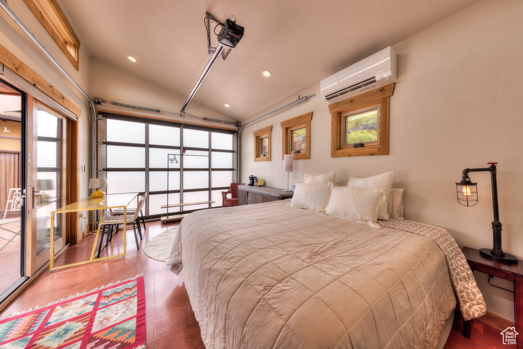 Bedroom with vaulted ceiling, a wall unit AC, recessed lighting, and access to exterior