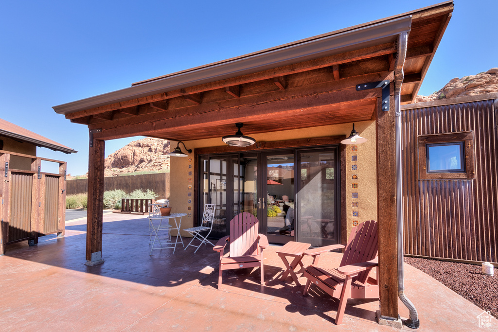 View of patio with a mountain view and ceiling fan