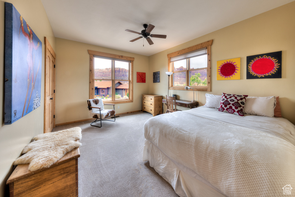 Bedroom featuring carpet floors, baseboards, and a ceiling fan