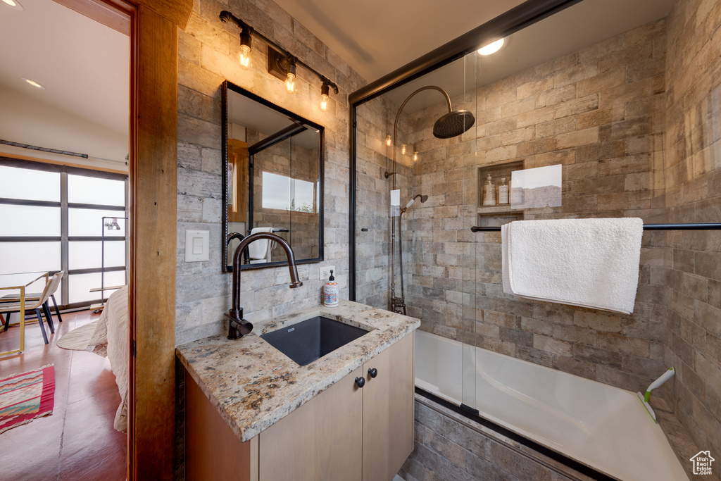 Full bathroom featuring vanity and tiled shower / bath combo