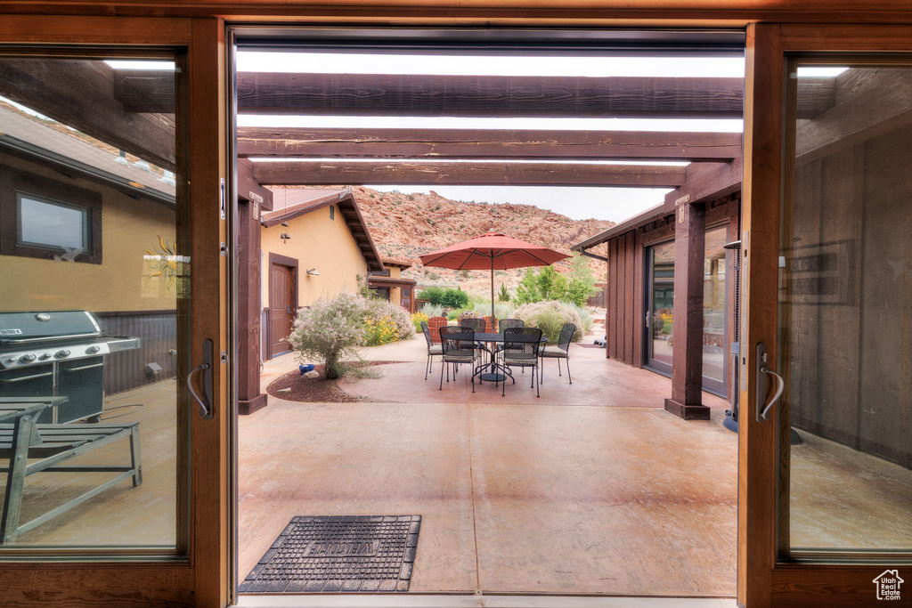 View of patio featuring area for grilling and outdoor dining area