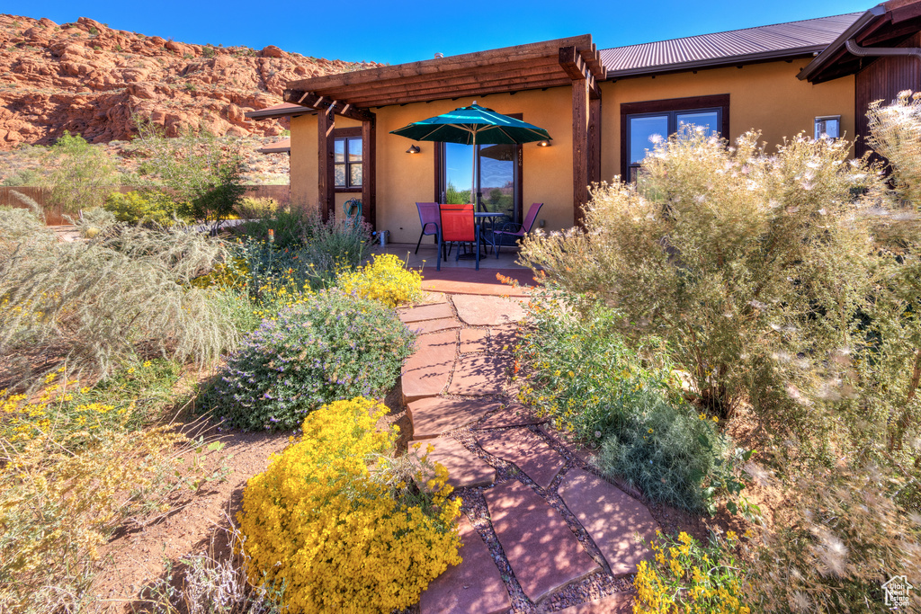 View of front of property featuring a patio and a mountain view
