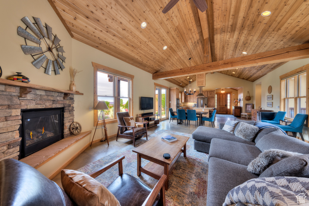Living area featuring wooden ceiling, a stone fireplace, recessed lighting, baseboards, and ceiling fan