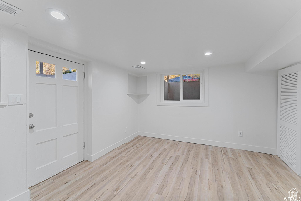 Below grade area featuring light wood-style floors, recessed lighting, and baseboards