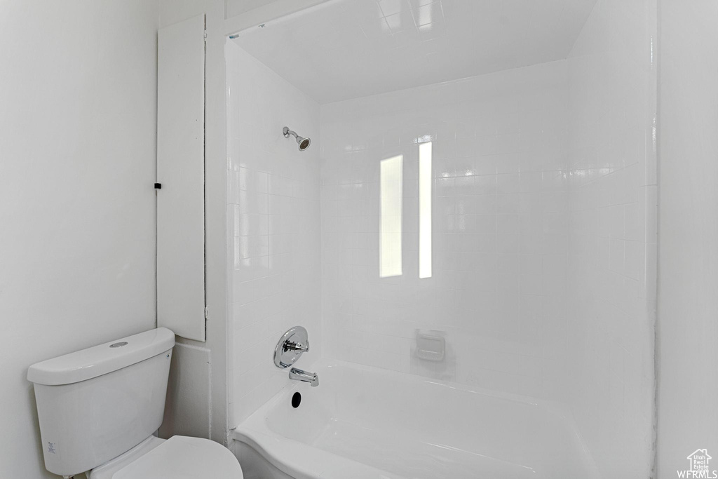 Full bath featuring toilet and shower / bath combination