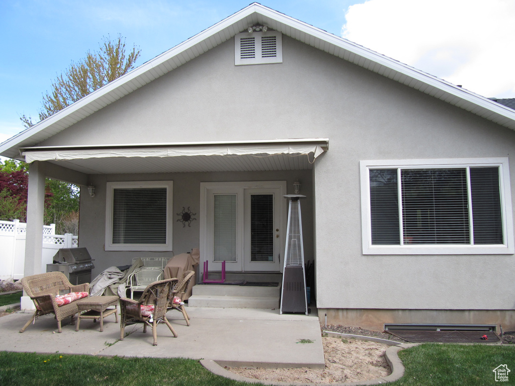 Rear view of property featuring stucco siding and a patio