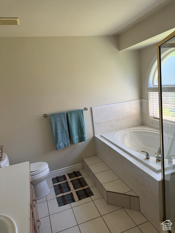 Bathroom with vanity, a bath, toilet, tile patterned flooring, and a shower with shower door