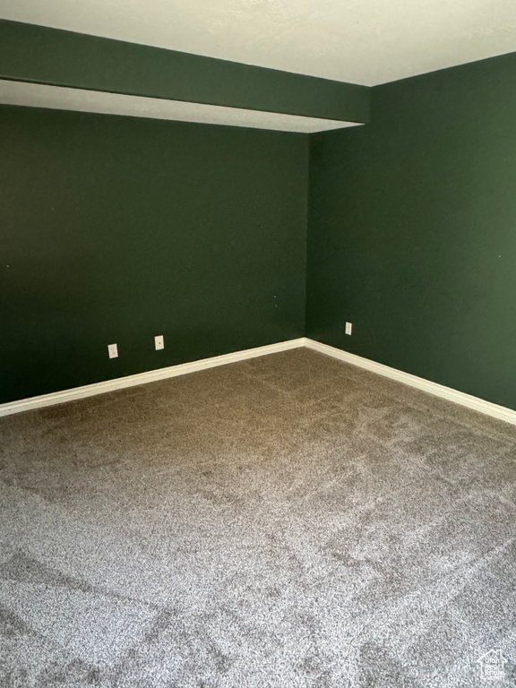 Unfurnished room featuring carpet and baseboards