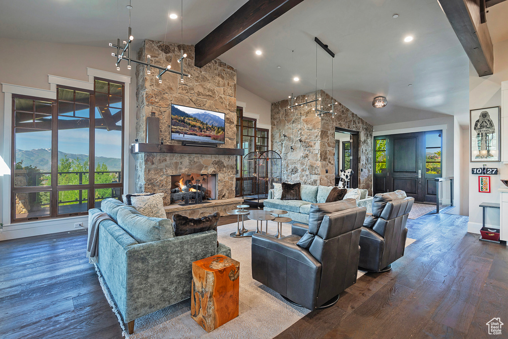 Living area featuring wood finished floors, healthy amount of natural light, beamed ceiling, a fireplace, and recessed lighting