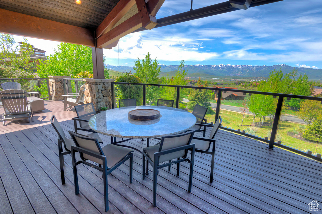 Wooden terrace with a mountain view and outdoor dining space