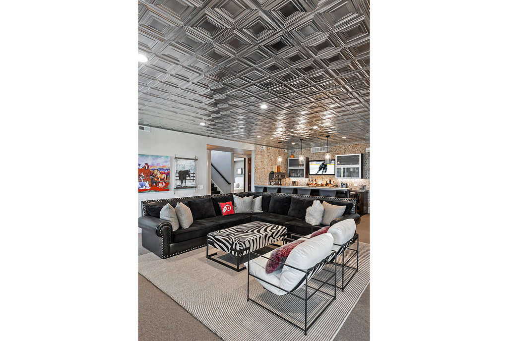 Carpeted living area featuring an ornate ceiling