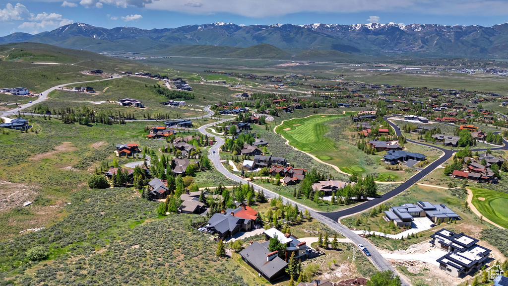 View of property location with mountains, nearby suburban area, and a golf club