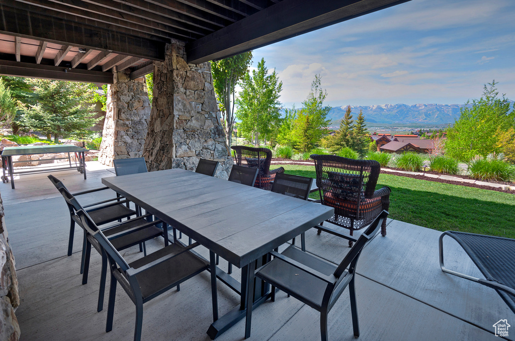 View of patio / terrace featuring a mountain view and outdoor dining space